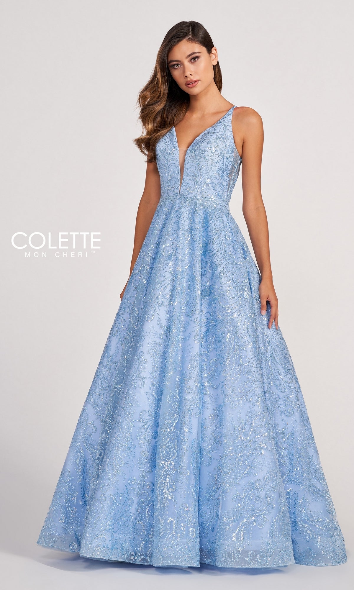 A woman wears a sleeveless Light Blue V-Neck Prom Dress with Glitter Print, standing against a plain background.